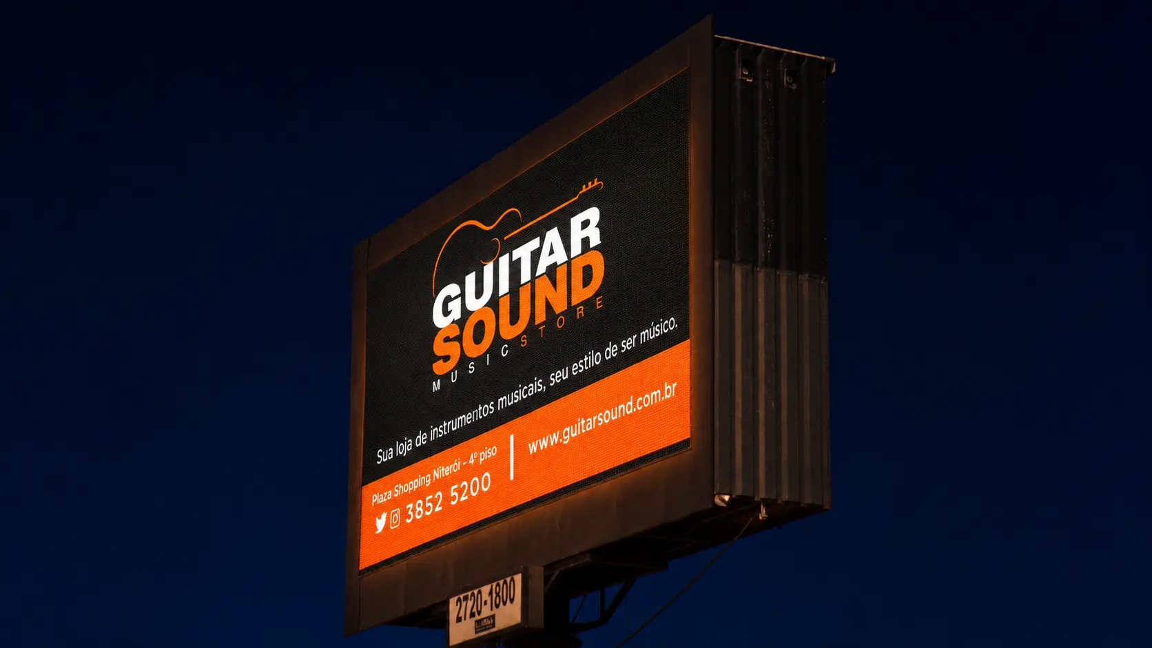Detalhe noturno da peça de branding da Guitar Sound em mídia exterior
